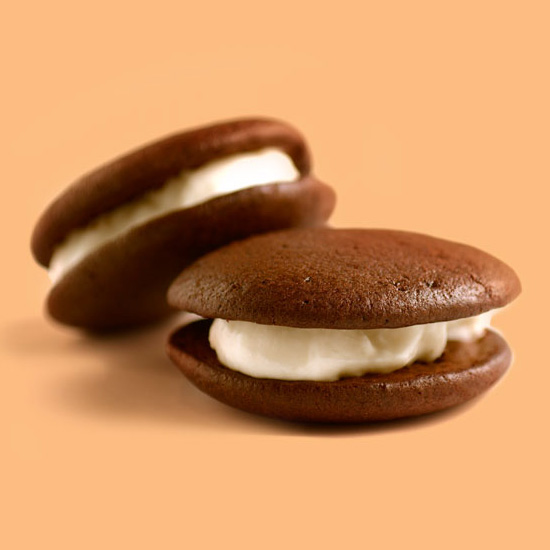 Printed photo of bag being tossed into the sky on top of grass.