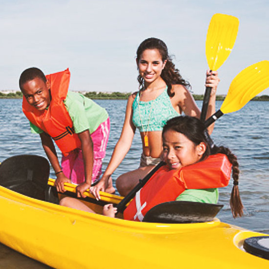 Printed photo of bag being tossed into the sky on top of grass.