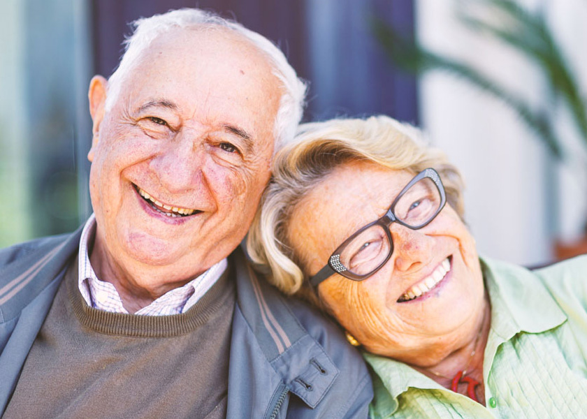 White canvas laptop sleeve with gray felt interior, silver zipper, and tan leather zipper pull.